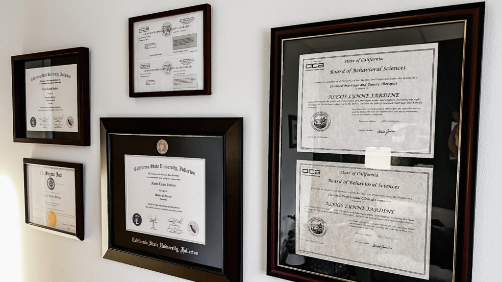 Framed certificates and diplomas hung on a wall, therapyworthwhile